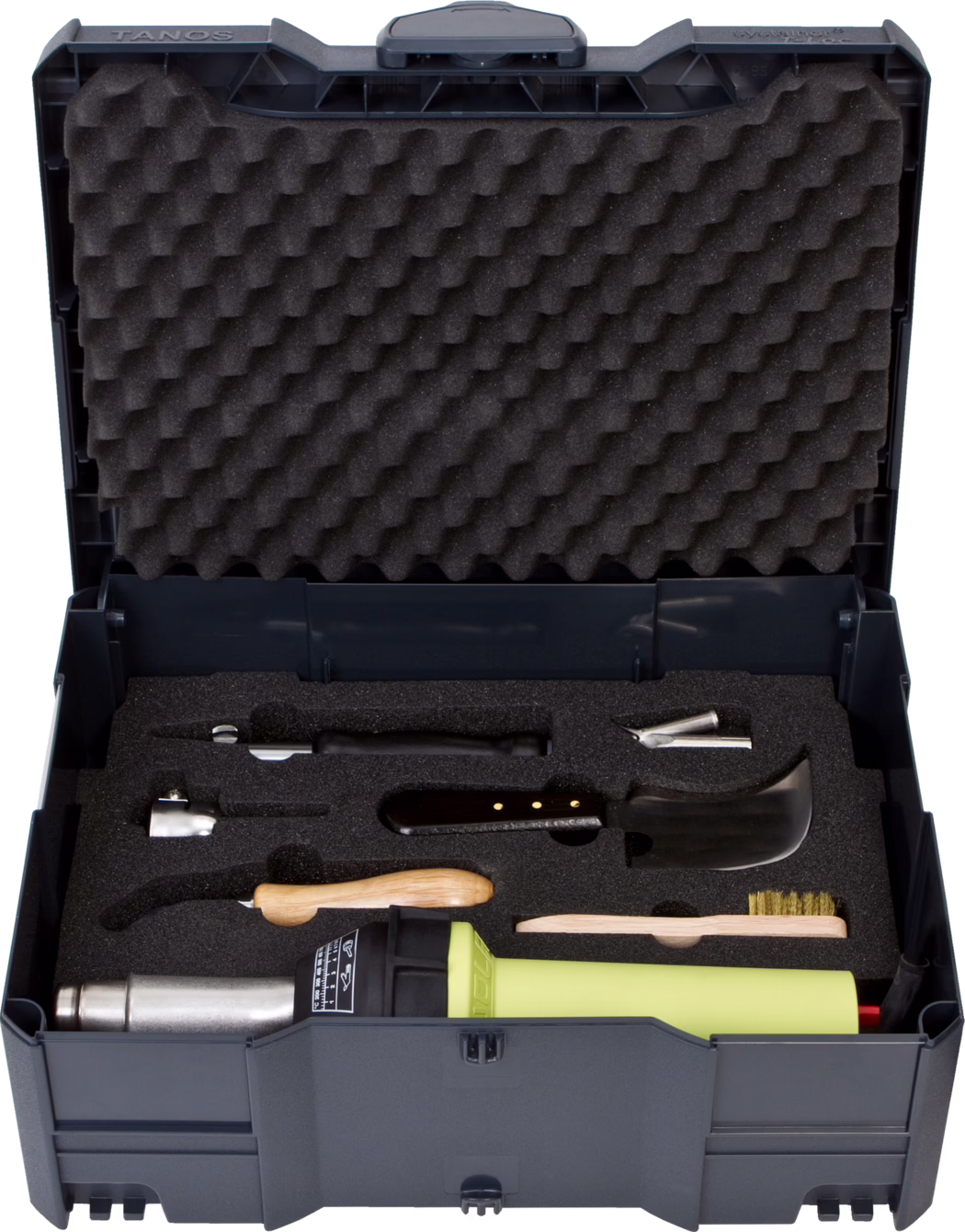 Coffret à outils en plastique gris foncé ouvert, avec mousse alvéolée dans le couvercle et insert en mousse noire découpé sur mesure. Contient un pistolet à air chaud vert citron, grattoirs à manche en bois, buses métalliques, une petite brosse métallique et d'autres accessoires rangés dans leurs emplacements.